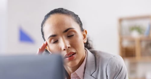 Woman with Headache at Her Desk