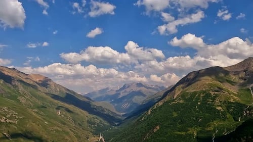 Aerial View of Majestic Mountain Range Under Blue Sky