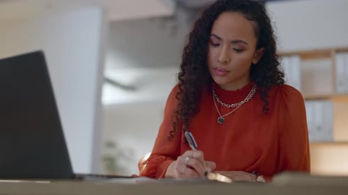 Laptop, thinking and writing by business woman in office at night brainstorming