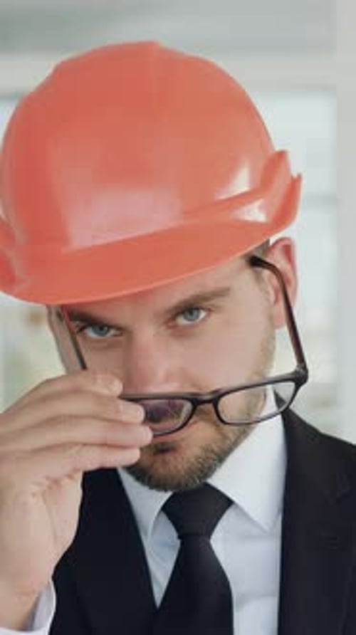 Goodlooking Successful Highskilled Stylish Bearded Architect in Glasses and Safety Helmet Poses on