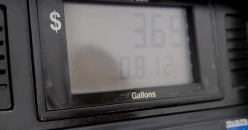 Gas station pump screen filling up and pumping slowly to 5 dollars and a little over a gallon with o