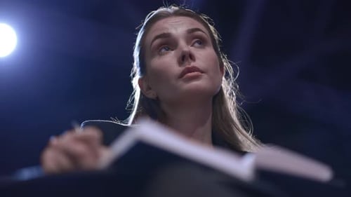 Young Woman Thinking and Writing in Notebook