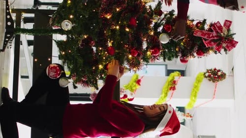 Couple Decorating a Christmas Tree with Festive Decorations