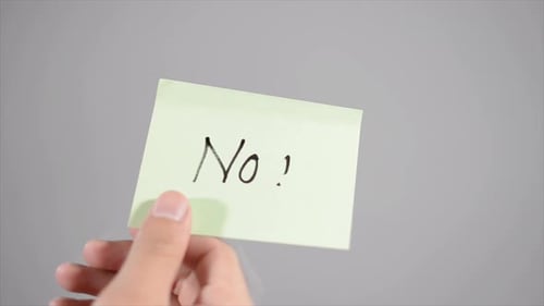 Hand Affixes and Removes "No!" Sticky Note