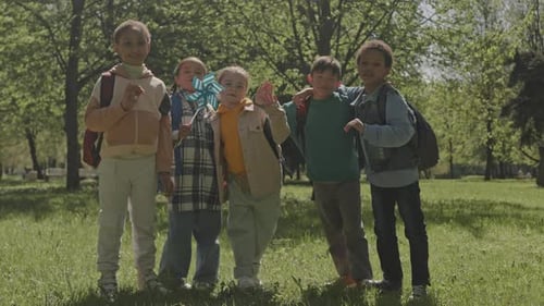 Group of Happy Kids Posing Together on Camera in Park