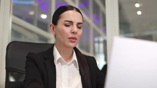 Brunette Female Working with Computer and Having Sharp Headache in Office