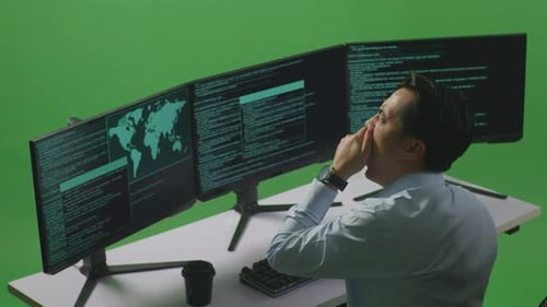 Man Yawning Before Sleeping While Write Code With Multiple Computer Screens In Green Screen Studio
