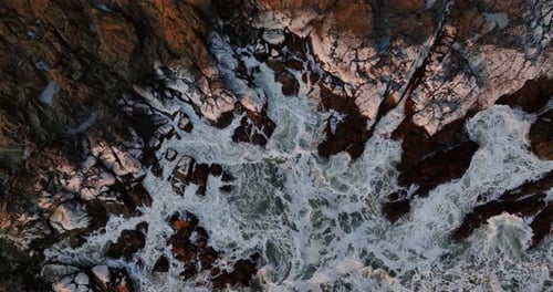 Aerial View Of Waves Crashing On Rocks