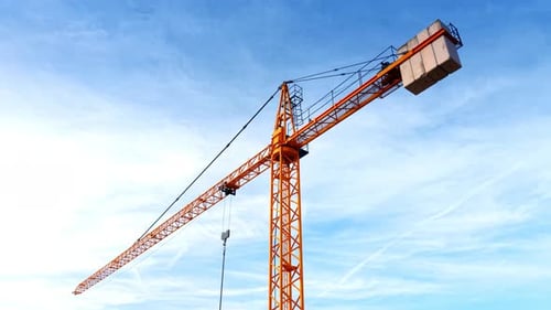 Rising to the top of the yellow construction crane. Revealing cityscape on the mountain
