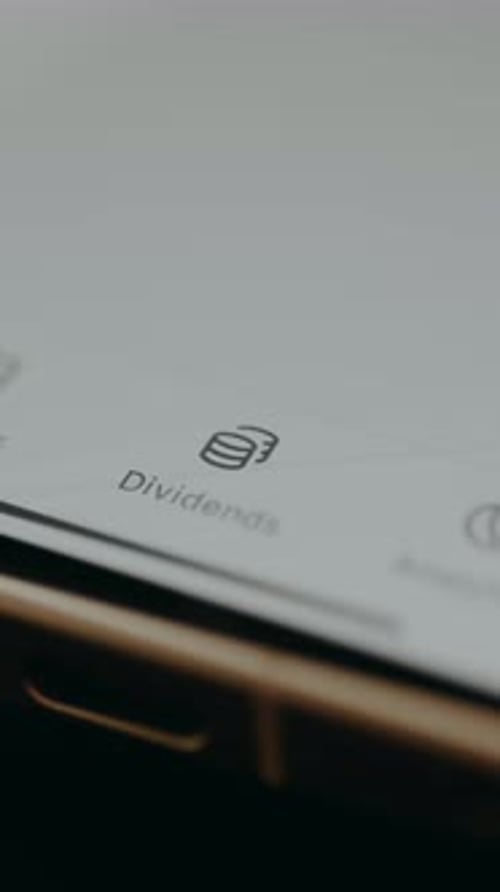 User Selects the Dividends Section with a Coin Icon From a Financial Application Interface
