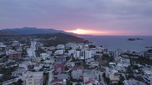 Drone pullback over coastal village Ksamil in riviera of Southern Albania