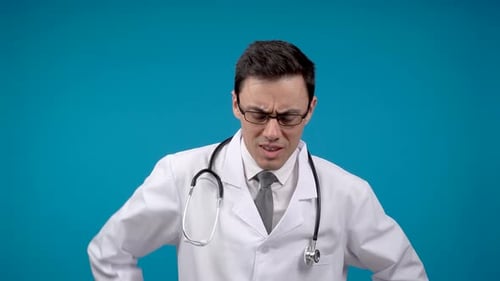 Discontented Doctor with Stethoscope Standing in Studio