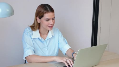 Happiness young businesswoman using laptop computer on desk in living room at home office.