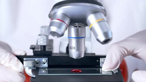 Microscope Analyzing Blood Sample in Lab