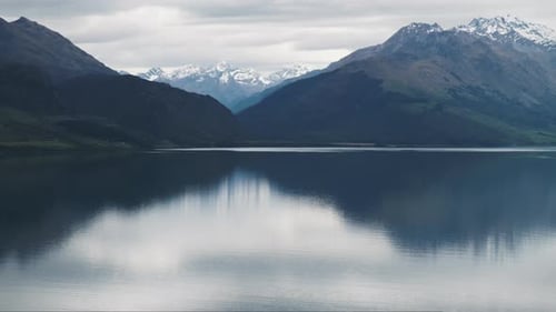 Peaceful snow capped mountain reflections in still quiet Lake