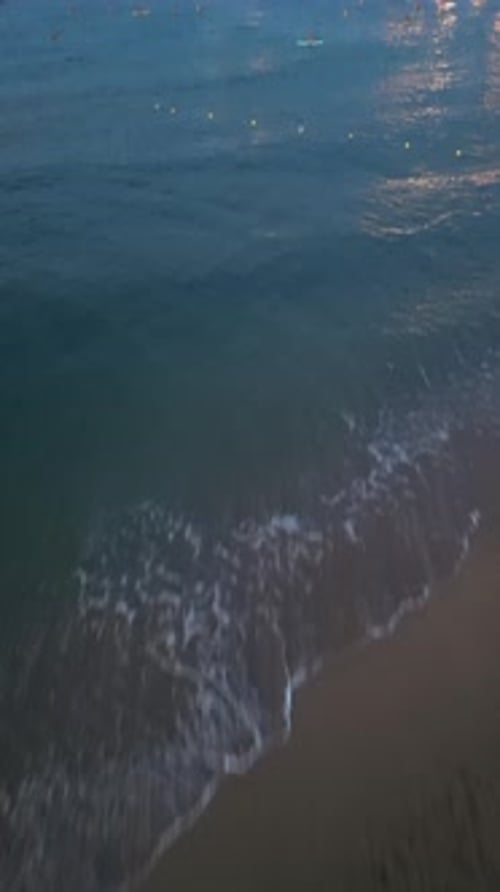 Aerial video on Barcelona's coastline people doing a sap.