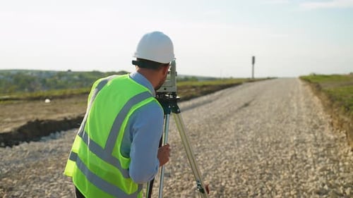 Surveyor Engineer Using Theodolite Measuring Road Construction Site