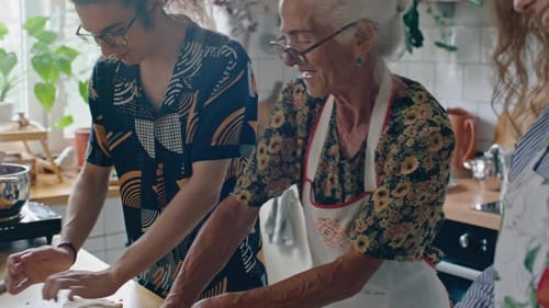 Family Kneading Dough Together at Kitchen Table