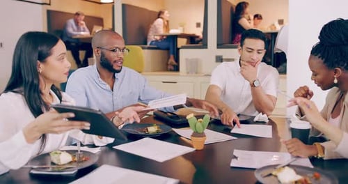 4k video footage of a group of young coworkers brainstorming over a lunch meeting in a restaurant