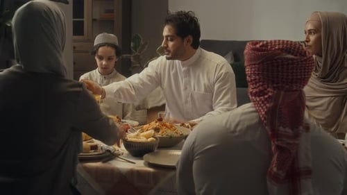 Big Family Celebrating Muslim Holiday of Eid al-Fitr at Festive Dinner