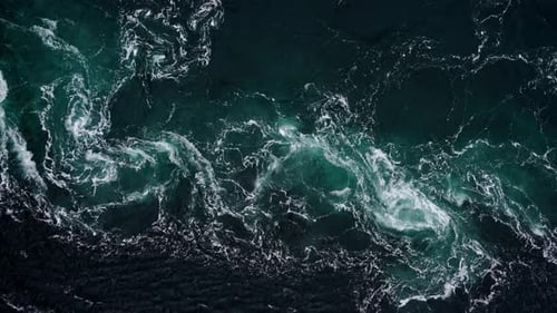 Drone Video with Birdseye View of the Abstract and Powerful Water Currents Rapids and Whirlpools of