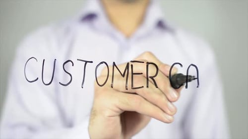 Man Writing Customer Care on Clear Surface