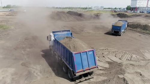 Aerial View of Excavator Scoop Clay Soil to a Dump Truck Scene Activity at the Construction Site