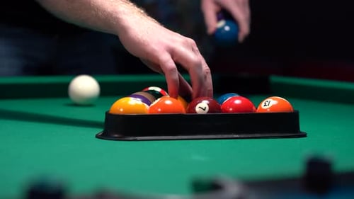 Racking the balls for the first break in pool game