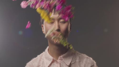 Young Adult Surrounded by Floating Flowers