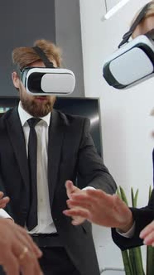 Colleagues Using VR Headsets in Modern Office Setting