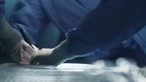 Surgeons using surgical instruments during operation