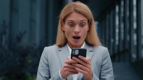 Closeup Enthusiastic Happy Businesswoman Receiving Notification Reading Good News on Telephone