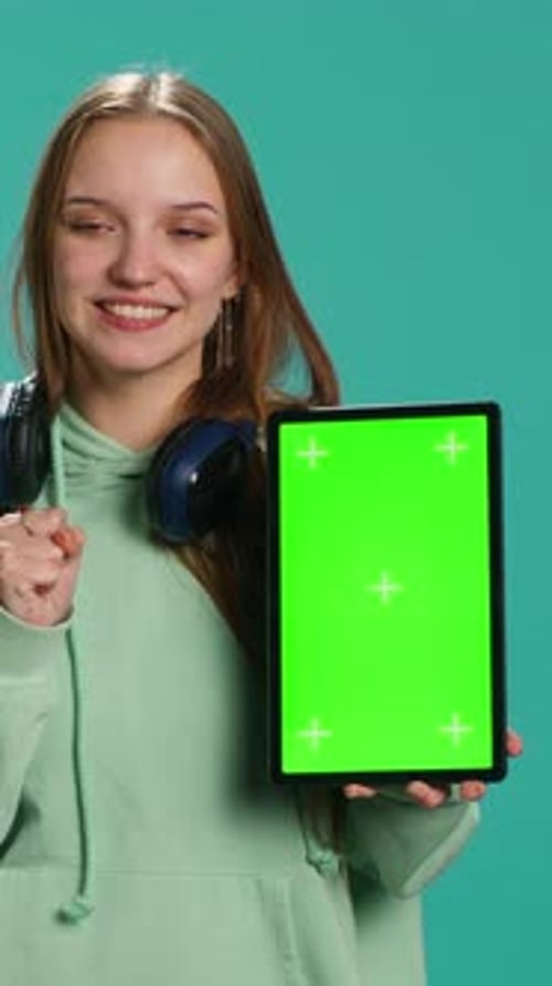 Vertical Video Portrait of Woman Presenting Tablet with Chroma Key Display