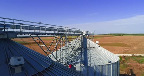 Aerial view. Metal grain elevator in agricultural zone. Grain warehouse
