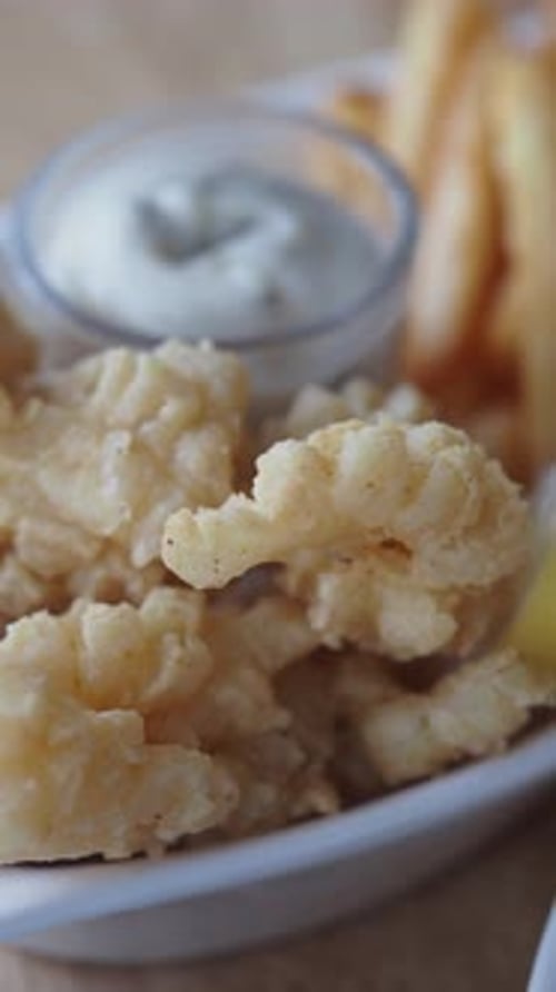 Enjoying Crispy Fried Food with Fresh Lemon Slice