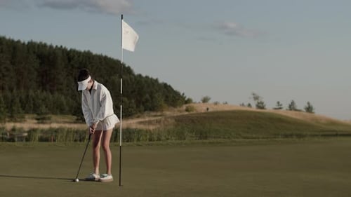 Young Adult Golfing on a Sunny Green Course
