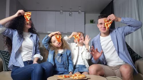 Happy Family Eating Pizza Together at Home