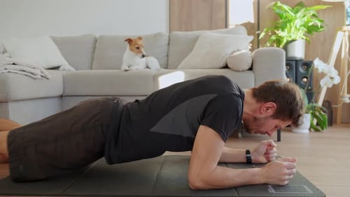 Man Doing Plank Exercise on Mat at Home