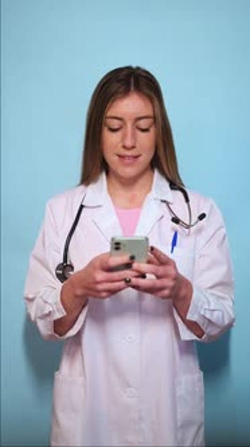 Young Woman Doctor Uses Cell Phone