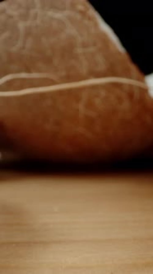 Vertical video. Parts of a Broken Coconut on the Table, the Camera Passes Through Them in the Cracks