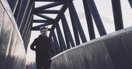 Adult man running athlete sprinting workout challenge training endurance in urban city