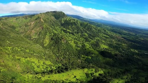 Aerial View of Rolling Hills Green Landscape and Blue Skies in Kauai Hawaii