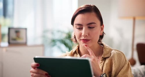 Young Woman Using Tablet Device at Home