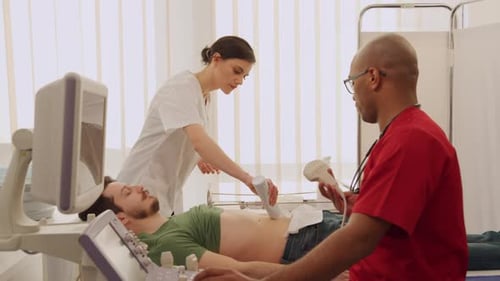 Doctor Using Ultrasound Machine on Patient in Hospital