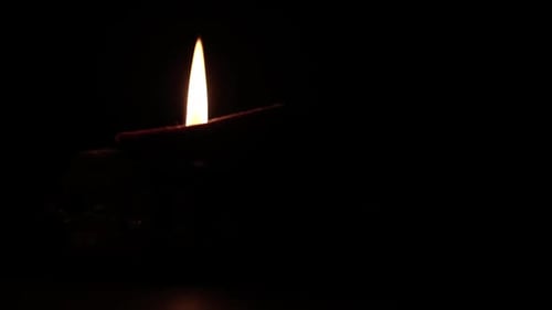 Single Diya Lamp Burning in the Darkness