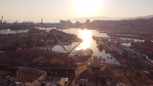 Genoa's historic center at sunset, highlighting the bustling port and colorful buildings, aerial vie