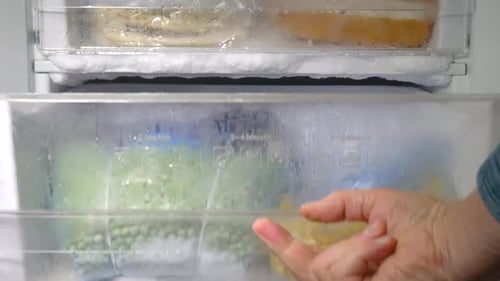 Freezer Drawer Filled with Frozen Food in Bags