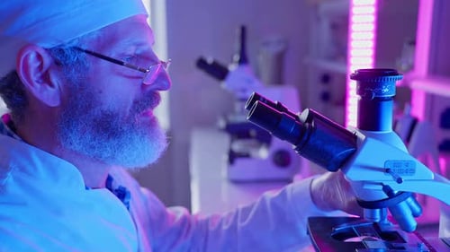 Scientist Uses Microscope in Brightly Lit Laboratory