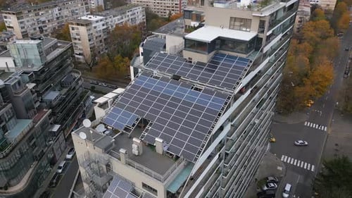 Drone Flight Along the Facade of a Modern Office or Residential Building with Solar Panels on the