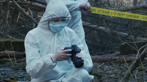 Forensic Specialist Working in the Forest Police Criminalists Collecting Evidence and Making